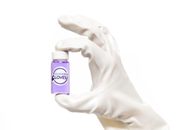 Butadyl Laboratory Gloves holding a put of purple liquid