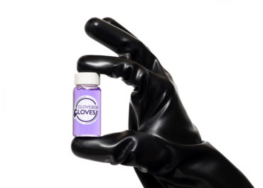 Butyl Laboratory Glove holding a Glovebox gloves purple liquid