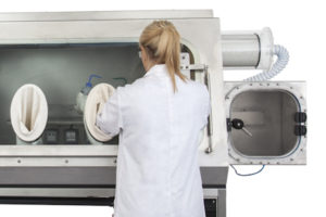 Analyst working on a laboratory glovebox