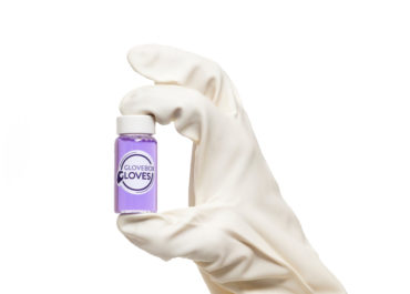 Nitrile Laboratory Glove holding a Glovebox gloves purple liquid